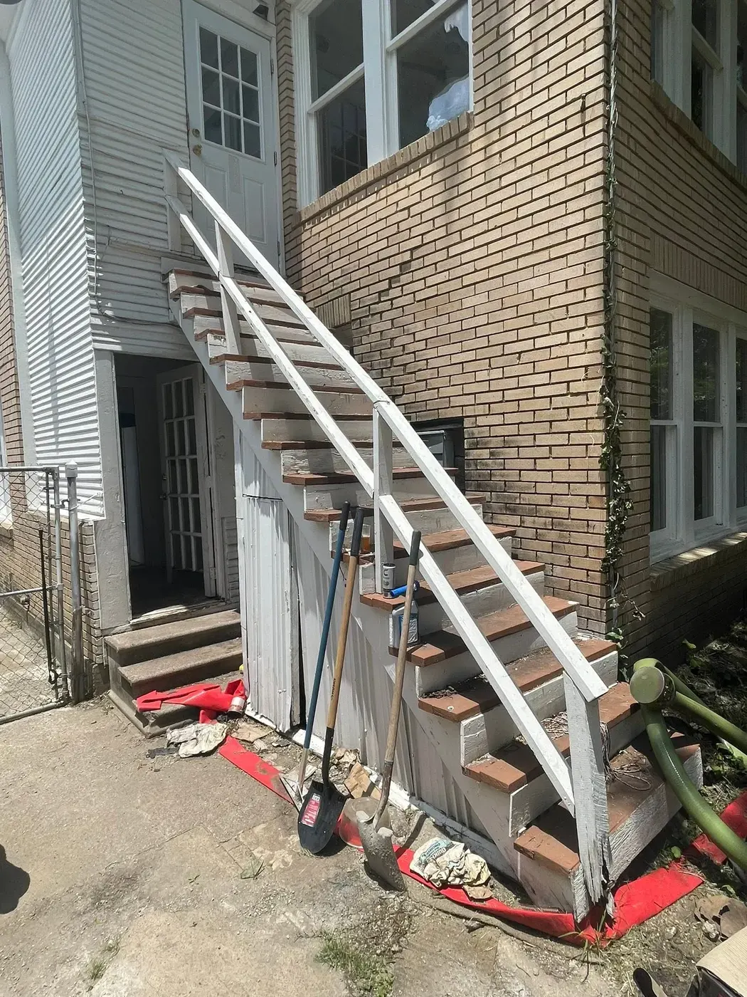 Weathered exterior staircase before painting by RGS General Contracting