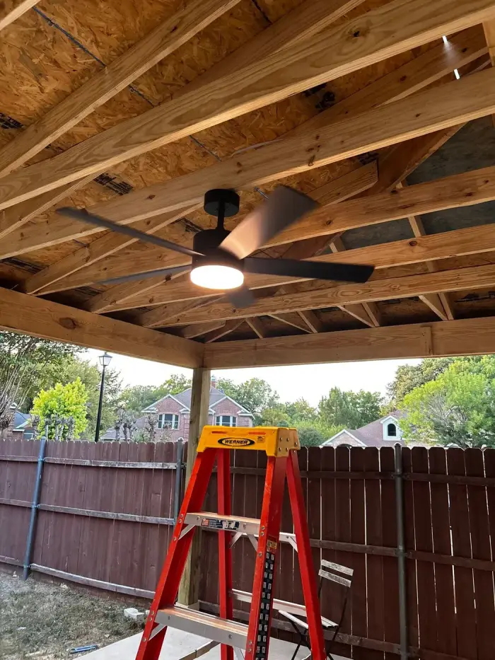 Covered patio ceiling with fan and exposed wood framing by RGS General Contracting