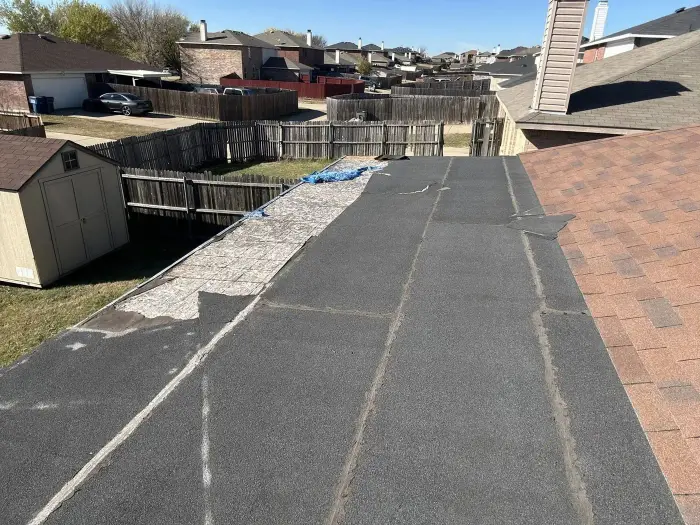 Storm-damaged roof before replacement by RGS General Contracting
