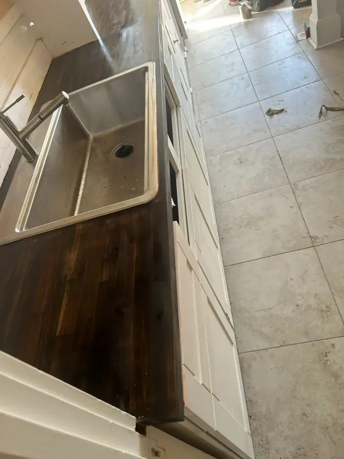 Stained butcher-block countertop with undermount sink by RGS General Contracting