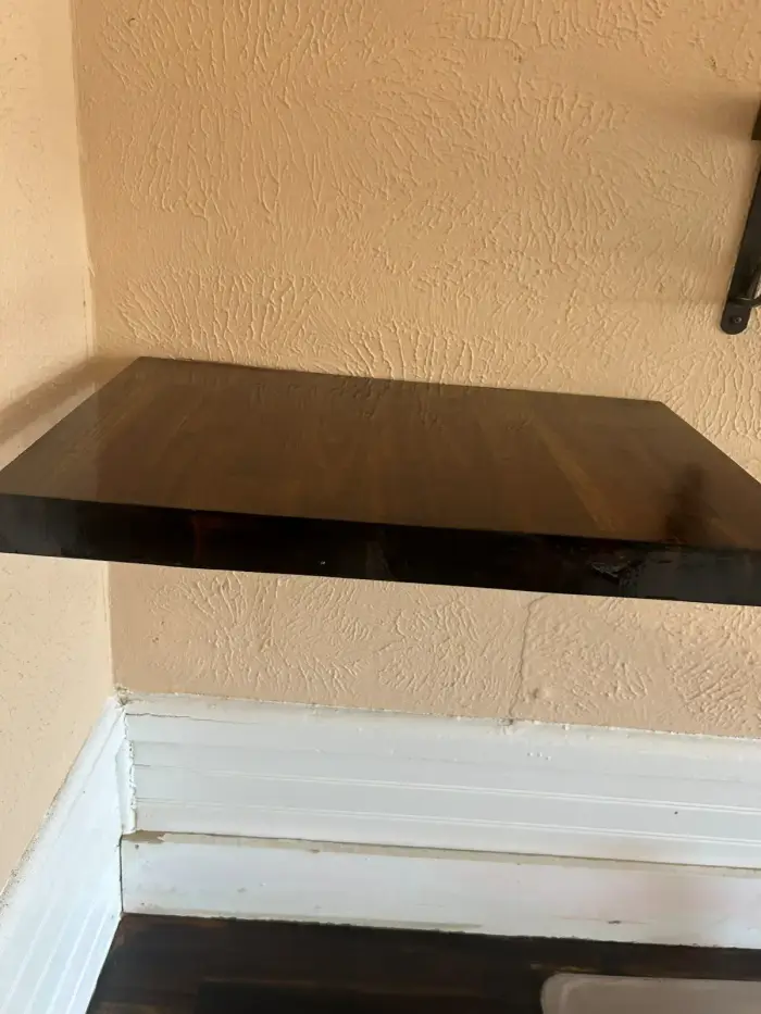 Custom stained wood floating shelves installed by RGS General Contracting